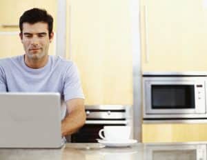mid adult man using a laptop