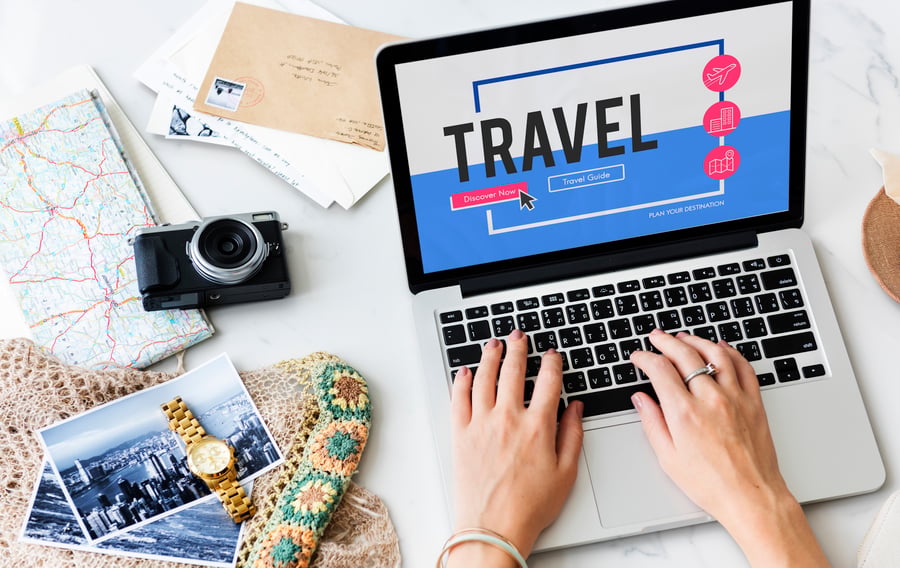 A beginner travel agent working on their computer