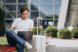 woman-travelling-working-computer-airport