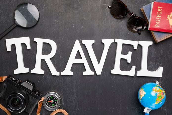 the word travel surrounded by travel related items